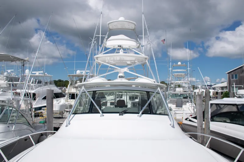  Yacht Photos Pics 2014 Viking 42 Express yacht docked at a marina under cloudy skies.