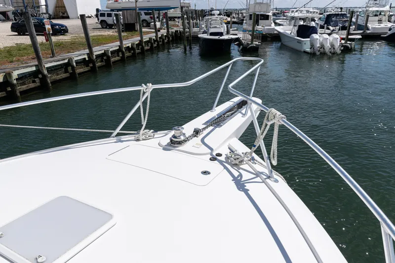 Yacht Photos Pics 2014 Viking 42 Express yacht docked in a marina, showcasing bow and railing.