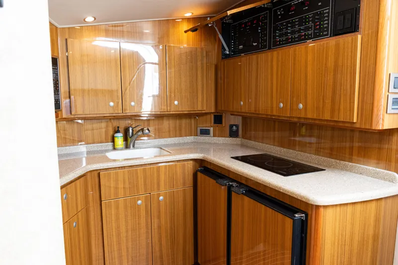  Yacht Photos Pics Luxurious 2014 Viking 42 Express yacht kitchen with wood cabinetry and modern appliances.