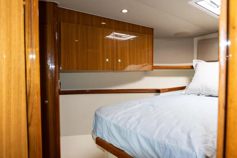  Yacht Photos Pics 2014 Viking 42 Express cabin interior with wooden cabinets and cozy bed.