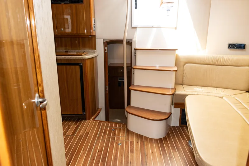  Yacht Photos Pics Interior of 2014 Viking 42 Express yacht with wooden flooring and beige seating.