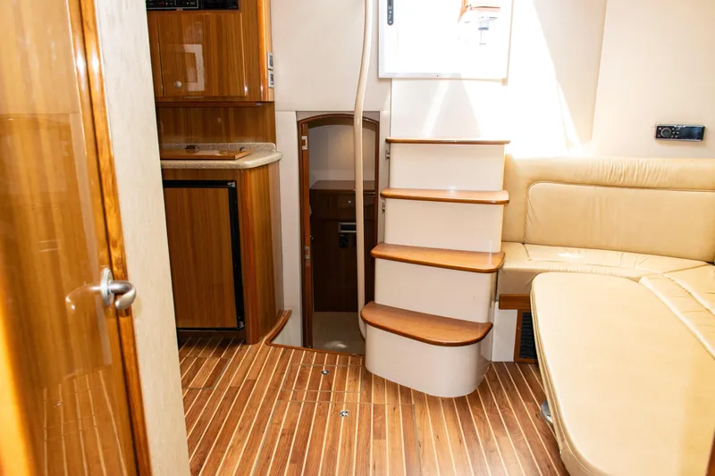  Yacht Photos Pics Interior of 2014 Viking 42 Express yacht with wooden flooring and beige seating.
