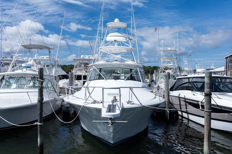  Yacht Photos Pics 2014 Viking 42 Express yacht docked among other boats under a blue sky.