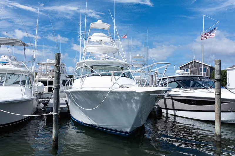 Yacht Photos Pics 2014 Viking 42 Express yacht docked at marina under blue sky.