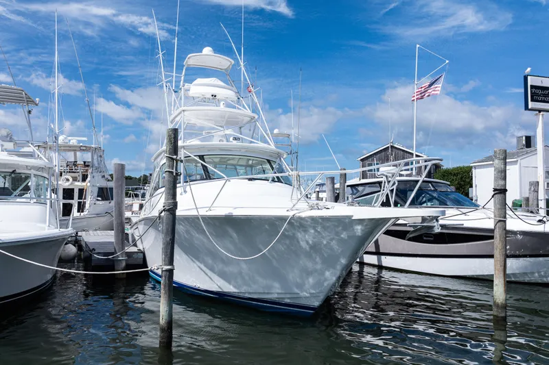  Yacht Photos Pics 2014 Viking 42 Express yacht docked at marina under clear blue sky.
