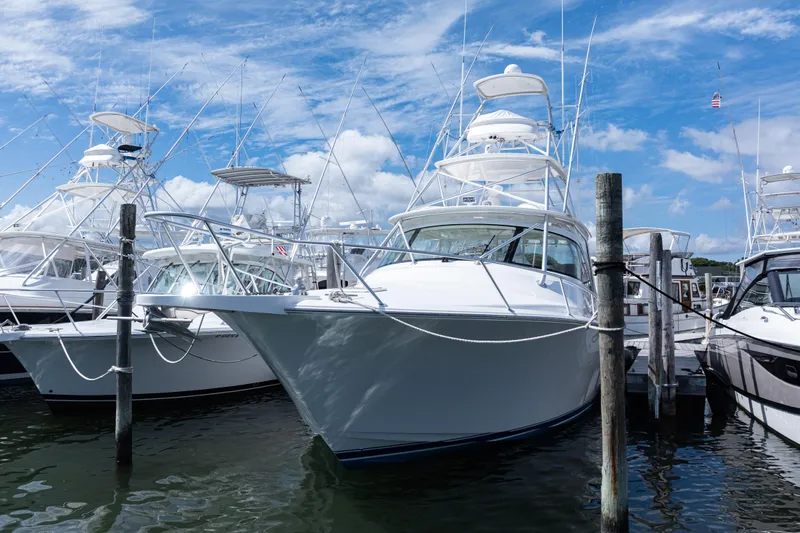  Yacht Photos Pics 2014 Viking 42 Express yacht docked at marina under blue sky.