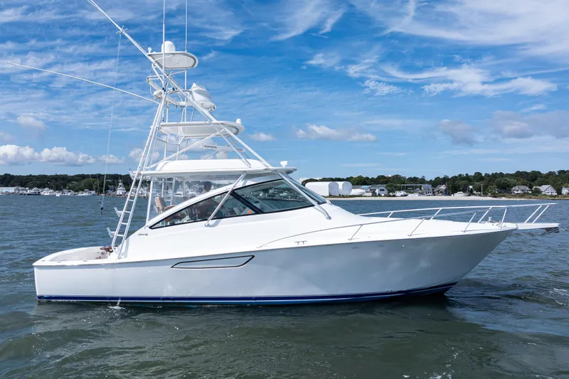  Yacht Photos Pics 2014 Viking 42 Express yacht cruising on a sunny day with blue skies.