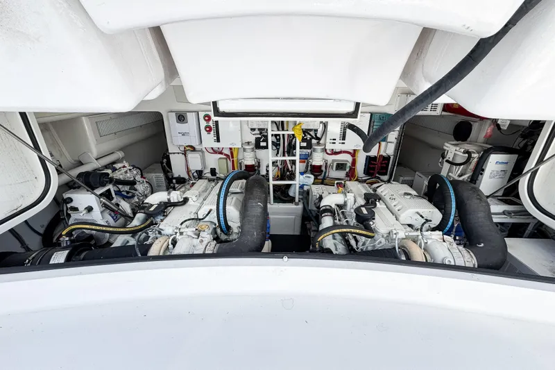  Yacht Photos Pics Engine room of a 2014 Viking 42 Express yacht, showcasing dual engines and mechanical systems.