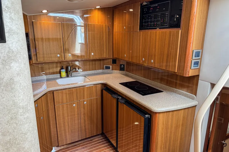  Yacht Photos Pics Luxurious 2014 Viking 42 Express yacht kitchen with wood cabinetry and modern appliances.