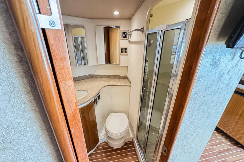 Yacht Photos Pics Luxurious bathroom in 2014 Viking 42 Express yacht with shower and wooden accents.