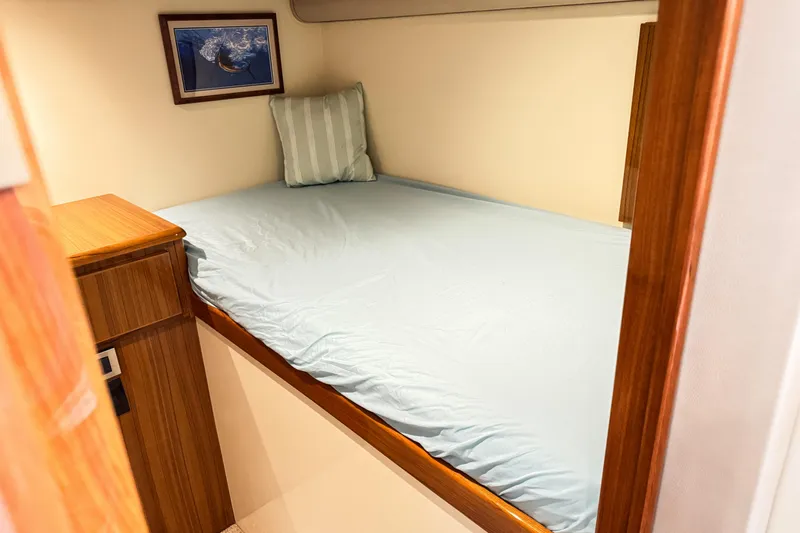  Yacht Photos Pics Cozy cabin bed in 2014 Viking 42 Express yacht with light blue bedding.