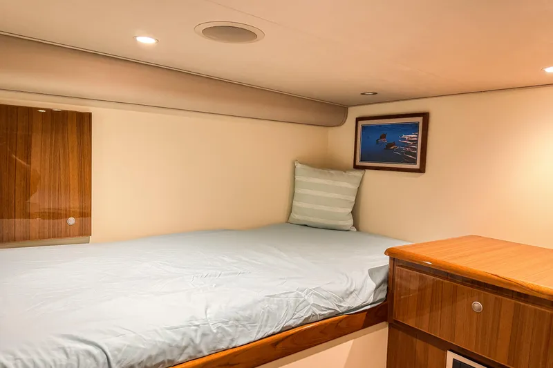  Yacht Photos Pics Cozy cabin interior of 2014 Viking 42 Express yacht with bed and wooden cabinetry.