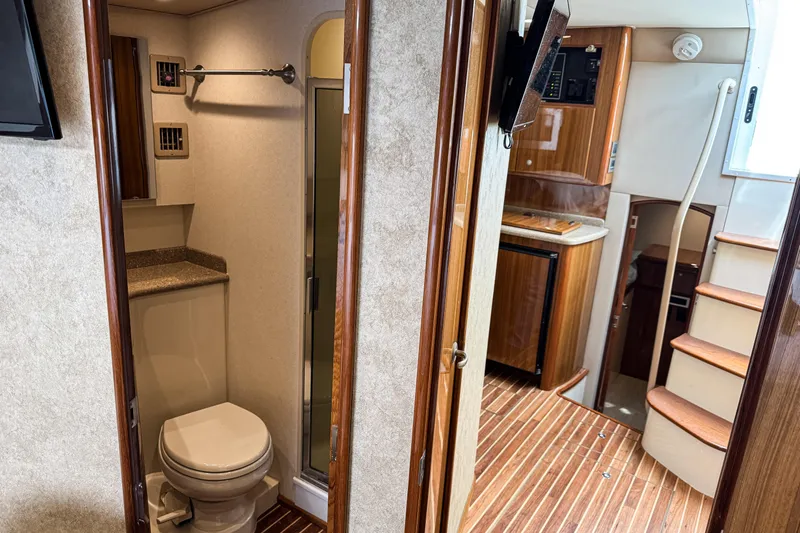  Yacht Photos Pics Interior of 2014 Viking 42 Express yacht with bathroom and wooden stairs.
