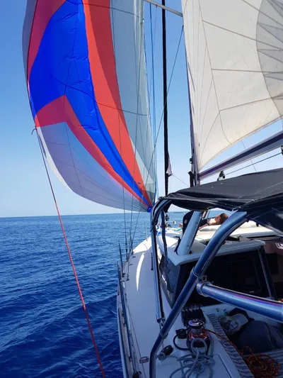  Yacht Photos Pics 2013 Beneteau Sense 43 sailing on open sea with colorful spinnaker.