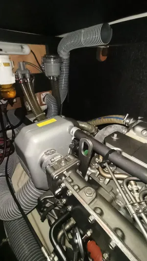  Yacht Photos Pics Engine compartment of a 2013 Beneteau Sense 43 sailboat, showcasing mechanical components and hoses.