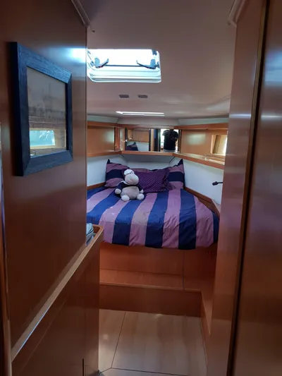  Yacht Photos Pics Cozy cabin interior of 2013 Beneteau Sense 43 sailboat with striped bedding.