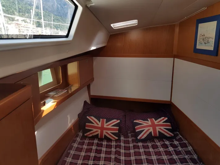  Yacht Photos Pics Cozy cabin interior of 2013 Beneteau Sense 43 yacht with Union Jack pillows and plaid bedding.
