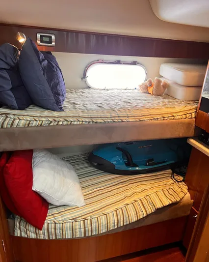  Yacht Photos Pics 2008 Tiara Yachts 4700 Sovran cabin with bunk beds and striped bedding.