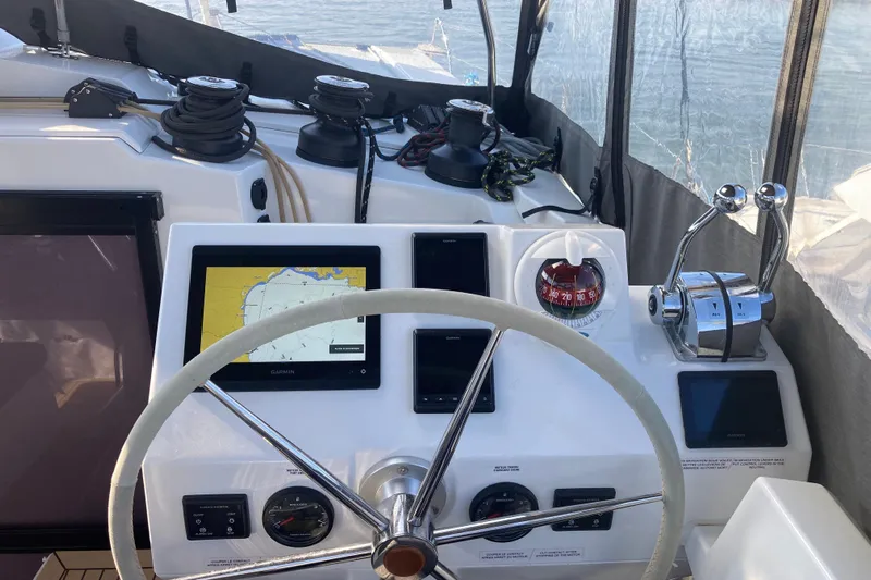  Yacht Photos Pics Helm of 2024 Fountaine Pajot Catamaran Astrea 42 with navigation equipment and controls.