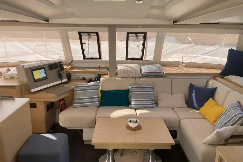  Yacht Photos Pics Luxurious interior of 2024 Fountaine Pajot Catamaran Astrea 42 with cozy seating and navigation equipment.