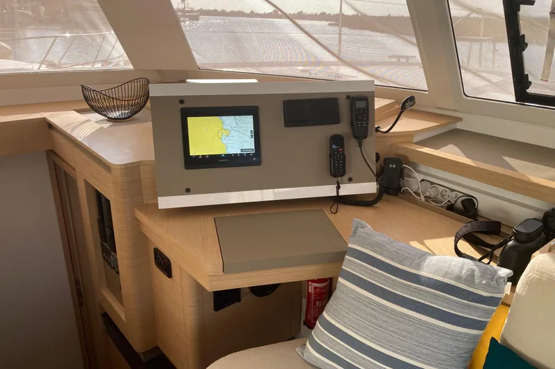  Yacht Photos Pics 2024 Fountaine Pajot Catamaran Astrea 42 interior helm with navigation equipment and cozy seating.