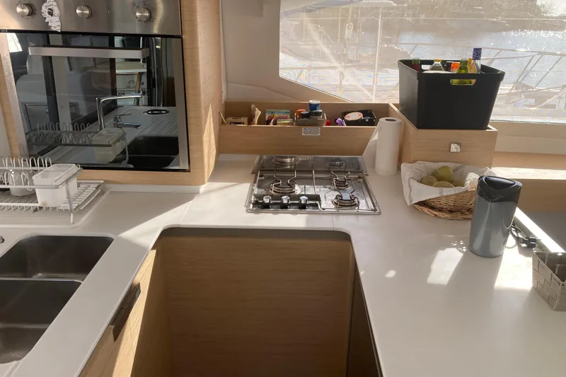  Yacht Photos Pics Modern kitchen in 2024 Fountaine Pajot Catamaran Astrea 42 with stove and sink.