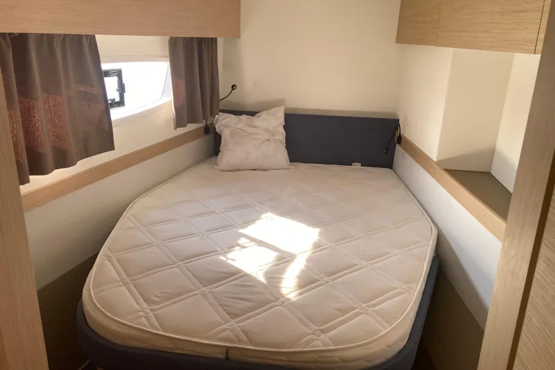  Yacht Photos Pics Cozy bedroom in 2024 Fountaine Pajot Catamaran Astrea 42 with natural light and modern design.