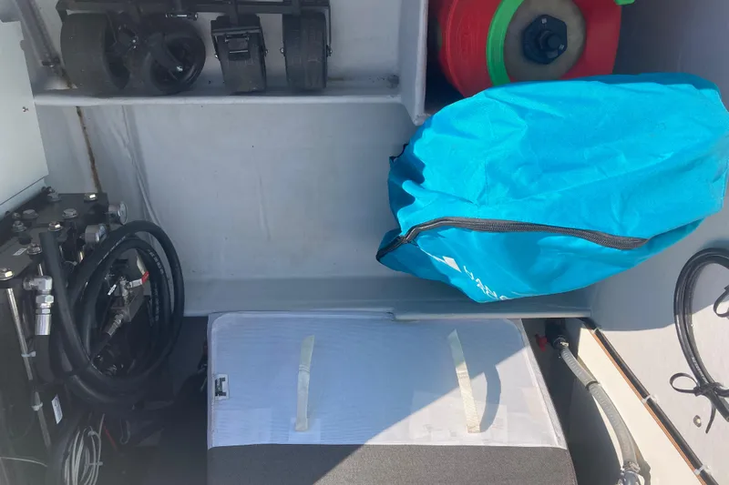  Yacht Photos Pics Storage compartment of 2024 Fountaine Pajot Catamaran Astrea 42 with equipment and blue cover.