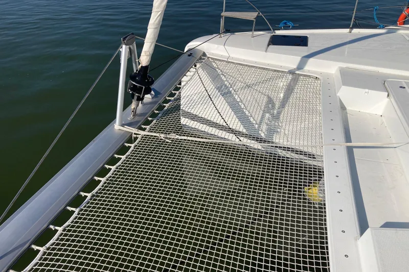  Yacht Photos Pics 2024 Fountaine Pajot Catamaran Astrea 42 deck with netting over water.