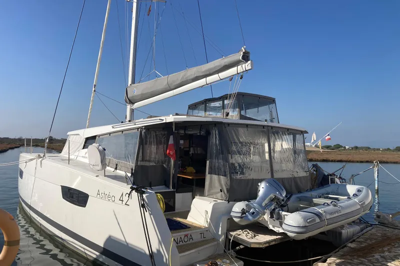  Yacht Photos Pics 2024 Fountaine Pajot Astrea 42 catamaran docked with inflatable boat attached.