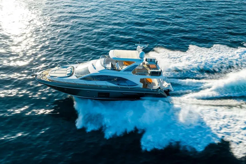  Yacht Photos Pics 2018 Azimut Flybridge yacht cruising on open sea, creating waves.