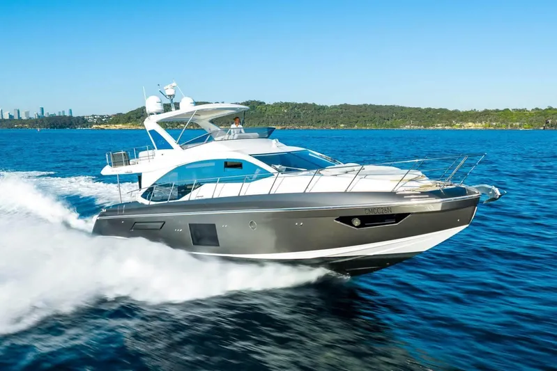  Yacht Photos Pics 2018 Azimut Flybridge yacht cruising on open water, with scenic coastline in the background.