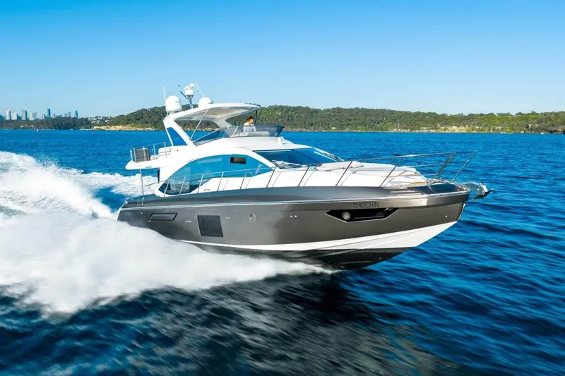  Yacht Photos Pics 2018 Azimut Flybridge yacht cruising on blue ocean near coastline.