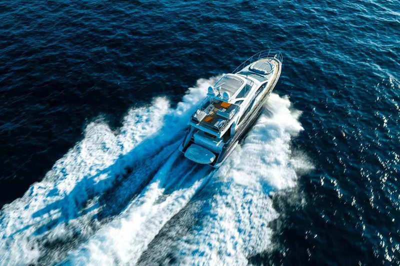  Yacht Photos Pics 2018 Azimut Flybridge yacht cruising on open blue sea, aerial view.