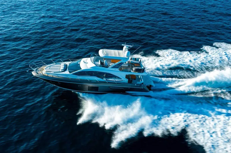  Yacht Photos Pics 2018 Azimut Flybridge yacht cruising on open blue sea, creating white waves.