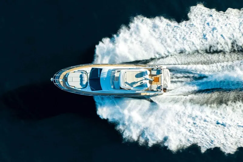  Yacht Photos Pics Aerial view of 2018 Azimut Flybridge yacht cruising on open water.