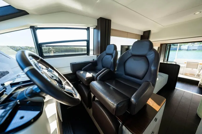  Yacht Photos Pics 2018 Azimut Flybridge yacht interior with luxurious leather seating and modern steering controls.