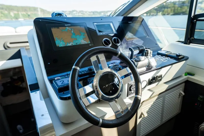  Yacht Photos Pics 2018 Azimut Flybridge yacht helm with navigation screens and steering wheel.