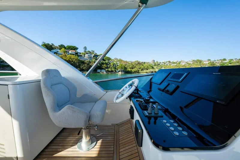  Yacht Photos Pics 2018 Azimut Flybridge yacht helm with modern controls and scenic waterfront view.