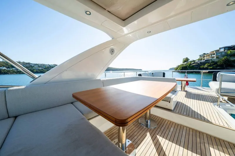  Yacht Photos Pics Luxurious 2018 Azimut Flybridge yacht with elegant deck seating and scenic waterfront view.