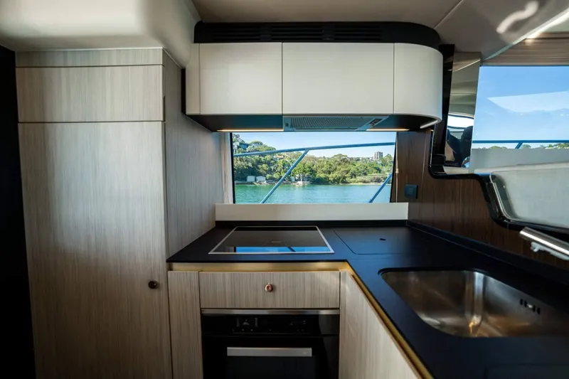  Yacht Photos Pics Luxurious 2018 Azimut Flybridge yacht kitchen with modern appliances and scenic window view.