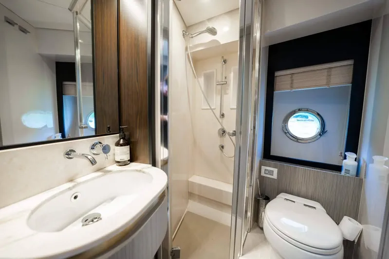  Yacht Photos Pics Luxurious 2018 Azimut Flybridge yacht bathroom with modern fixtures and porthole window.