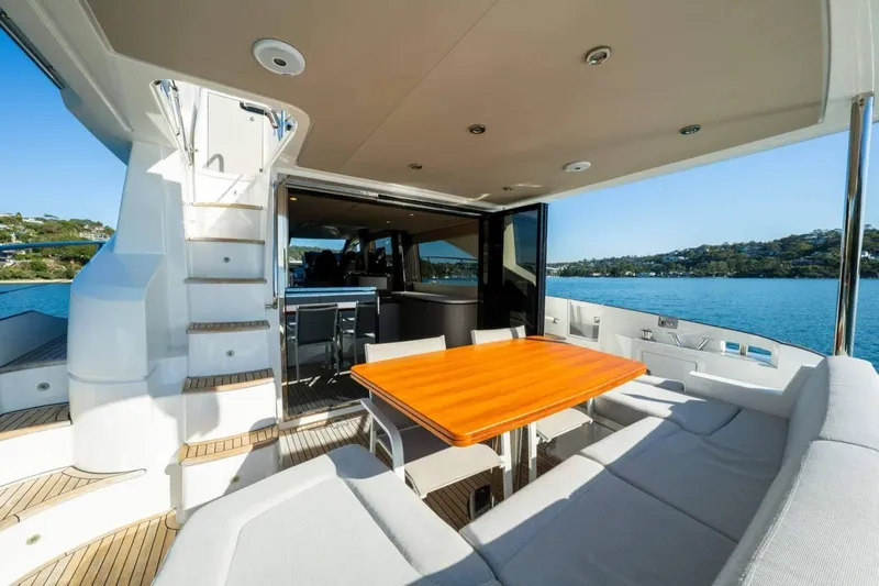  Yacht Photos Pics Luxurious 2018 Azimut Flybridge yacht with elegant outdoor seating and scenic ocean view.