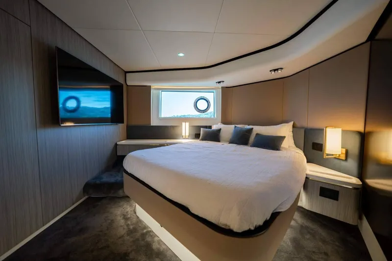  Yacht Photos Pics Luxurious bedroom interior of 2018 Azimut Flybridge yacht with modern design and cozy ambiance.