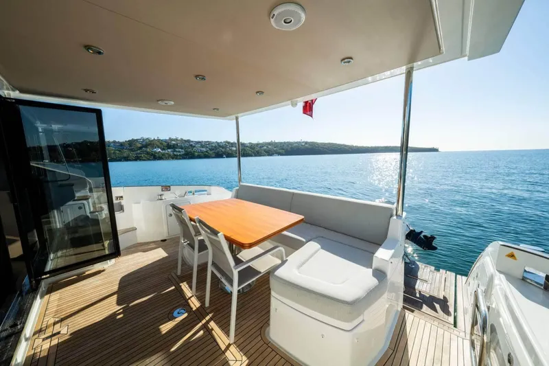  Yacht Photos Pics Luxurious 2018 Azimut Flybridge yacht deck with seating, overlooking serene ocean view.