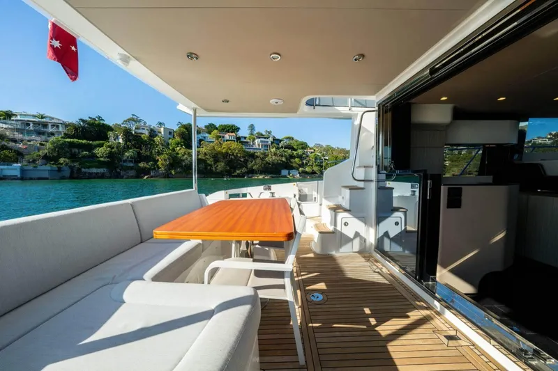  Yacht Photos Pics Luxurious 2018 Azimut Flybridge yacht deck with seating, table, and scenic waterfront view.