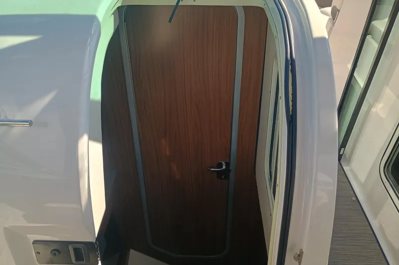350-004 - Brokerage Joe Yacht Photos Pics 2019 Four Winns H350 boat cabin door with wood finish and sleek design.
