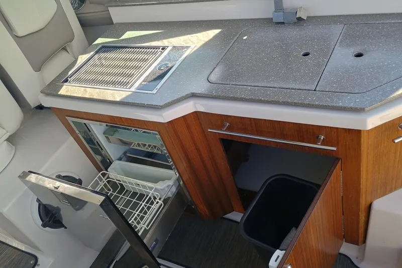 350-004 - Brokerage Joe Yacht Photos Pics 2019 Four Winns H350 boat kitchen with grill, sink, and storage cabinets.