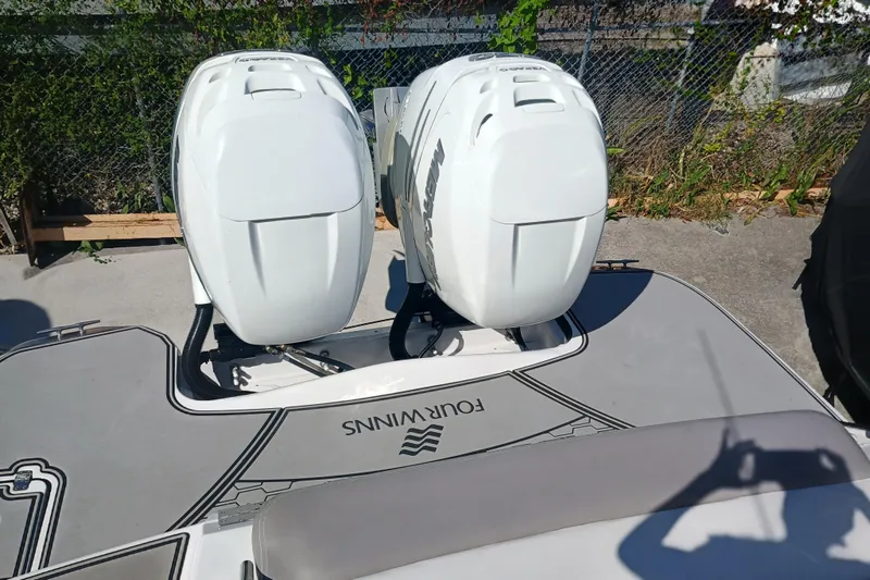 350-004 - Brokerage Joe Yacht Photos Pics 2019 Four Winns H350 boat with dual outboard engines, docked outdoors.