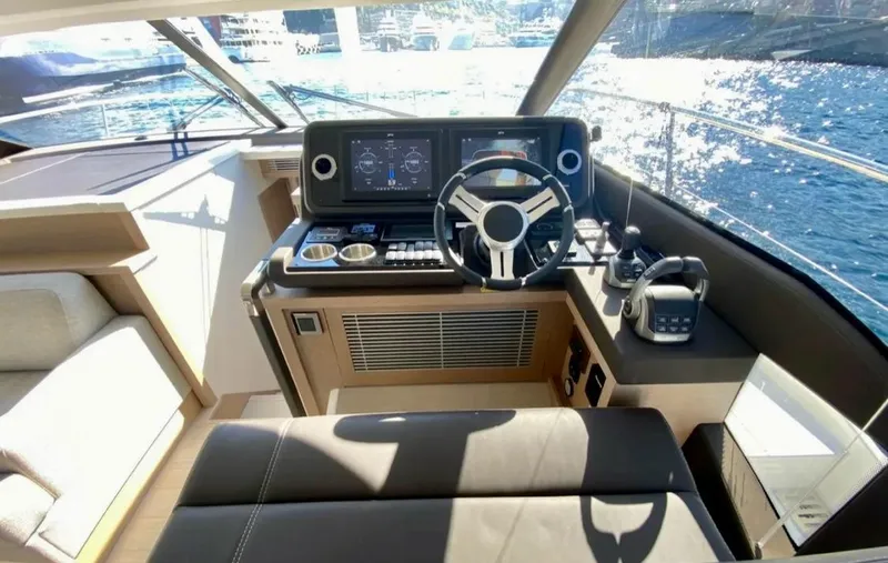 Yacht Photos Pics 2023 Prestige 520 yacht helm with modern controls and panoramic water view.